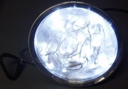 Image of LED light bulb in clamp-on reflector light fixture (turned on)